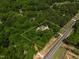 Aerial view of a secluded home with a large, wooded lot surrounded by lush greenery at 6237 Nc 96 Hwy W, Youngsville, NC 27596