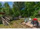 Backyard featuring a deck, above-ground pool, seating area and lush landscaping for entertainment at 6237 Nc 96 Hwy W, Youngsville, NC 27596