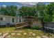 Home's backyard features a deck, ramp, above-ground pool, and lush landscaping for enjoying outdoors at 6237 Nc 96 Hwy W, Youngsville, NC 27596