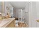 Bathroom offers gray walls, vinyl flooring, decorative vanity, granite counters and walk-in shower at 6237 Nc 96 Hwy W, Youngsville, NC 27596