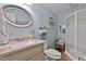 Bathroom with blue walls featuring a shower with a glass door and a tile floor at 6237 Nc 96 Hwy W, Youngsville, NC 27596