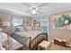 Cozy bedroom featuring a detailed wood bed frame, ceiling fan, and framed decor at 6237 Nc 96 Hwy W, Youngsville, NC 27596
