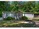 A full front exterior showing home with landscaped front yard and inviting front porch at 6237 Nc 96 Hwy W, Youngsville, NC 27596