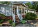 Inviting front porch featuring a cozy seating area, perfect for relaxing outdoors at 6237 Nc 96 Hwy W, Youngsville, NC 27596
