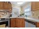 Kitchen featuring wood cabinets, white countertop, stainless steel appliances, and bright natural light at 6237 Nc 96 Hwy W, Youngsville, NC 27596