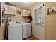 Bright laundry room features updated washer and dryer and access to exterior door at 6237 Nc 96 Hwy W, Youngsville, NC 27596