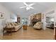 Spacious living room featuring a stone fireplace, ceiling fan, and stylish furnishings at 6237 Nc 96 Hwy W, Youngsville, NC 27596