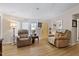 Cozy living room showcasing hardwood floors, comfortable seating, and natural light at 6237 Nc 96 Hwy W, Youngsville, NC 27596