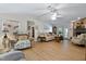 Cozy living room with ceiling fan, stone fireplace, and access to the outdoor area at 6237 Nc 96 Hwy W, Youngsville, NC 27596
