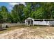View of a home's exterior outbuilding with a fence and treelined backdrop at 6237 Nc 96 Hwy W, Youngsville, NC 27596