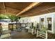 Covered porch with a wood ceiling and rocking chairs overlooking the yard at 6237 Nc 96 Hwy W, Youngsville, NC 27596