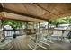 Outdoor porch with rocking chairs, greenery, and a wood plank ceiling at 6237 Nc 96 Hwy W, Youngsville, NC 27596