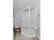 Bathroom shower with white and patterned glass enclosure and flooring at 6237 Nc 96 Hwy W, Youngsville, NC 27596