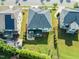 Aerial view of the property showcasing the backyard, screened-in porch, patio, and manicured lawn at 636 Copper Beech Ln, Wake Forest, NC 27587