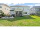 Spacious backyard featuring a screened-in porch, concrete patio, a well-maintained lawn, and a secure fenced perimeter at 636 Copper Beech Ln, Wake Forest, NC 27587