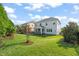View of the property's backyard, including a screened-in porch and an open lawn perfect for relaxing and recreation at 636 Copper Beech Ln, Wake Forest, NC 27587