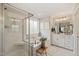 Bright bathroom features a separate shower and soaking tub with marble tile and white cabinets at 636 Copper Beech Ln, Wake Forest, NC 27587