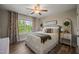Bright bedroom features a ceiling fan, large window, and stylish furnishings at 636 Copper Beech Ln, Wake Forest, NC 27587