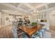 Dining area with a wooden table, chandelier lighting, and open access to a modern kitchen at 636 Copper Beech Ln, Wake Forest, NC 27587