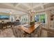 Open concept dining and living room featuring coffered ceilings and large windows at 636 Copper Beech Ln, Wake Forest, NC 27587