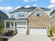 Charming two-story home with a brick and siding exterior and a two-car garage at 636 Copper Beech Ln, Wake Forest, NC 27587