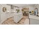 Bright kitchen with stainless steel appliances, an island, and floating shelves at 636 Copper Beech Ln, Wake Forest, NC 27587