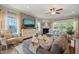 Cozy living room featuring a large sectional sofa, fireplace, and a mounted flat screen TV at 636 Copper Beech Ln, Wake Forest, NC 27587
