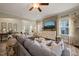 Comfortable living room with large sectional sofa, natural light, and stylish decor at 636 Copper Beech Ln, Wake Forest, NC 27587