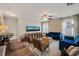 Spacious living room with a ceiling fan, comfortable seating, and two televisions at 636 Copper Beech Ln, Wake Forest, NC 27587