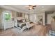 Bright main bedroom featuring tray ceiling, ceiling fan, ample natural light, and white furnishings at 636 Copper Beech Ln, Wake Forest, NC 27587