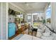Relaxing screened porch featuring rocking chairs, wicker furniture, and a mini fridge at 636 Copper Beech Ln, Wake Forest, NC 27587