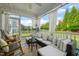 Inviting screened porch with rocking chairs and comfortable wicker furniture at 636 Copper Beech Ln, Wake Forest, NC 27587