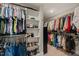 Walk-in closet with custom shelving and hanging rods to maximize organization at 636 Copper Beech Ln, Wake Forest, NC 27587
