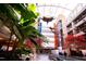 Bright airport interior with art installations, greenery, escalators, and ample natural light at 6416 Tanner Oak Ln, Raleigh, NC 27613
