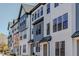 New construction townhouse with white siding, black trim, and a modern design at 6416 Tanner Oak Ln, Raleigh, NC 27613