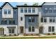 Modern townhome featuring gray and white siding, and a landscaped front yard at 6416 Tanner Oak Ln, Raleigh, NC 27613