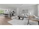 Spacious open-concept area with modern decor, flowing into a kitchen and dining area at 6416 Tanner Oak Ln, Raleigh, NC 27613