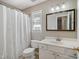 Clean bathroom with shower and tub, light colored vanity, and mirror with a clean aesthetic at 7019 Bellard Ct, Raleigh, NC 27617
