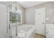Bathroom featuring large soaking tub, separate shower, and vanity with lots of light at 7019 Bellard Ct, Raleigh, NC 27617