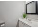 Bathroom featuring a white vanity, modern faucet, and decorative mirror at 7019 Bellard Ct, Raleigh, NC 27617