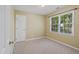 Bedroom with neutral carpet and paint, a bright window, and closet at 7019 Bellard Ct, Raleigh, NC 27617
