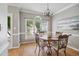 Cozy dining area with decorative light fixture, large window, and hardwood floors at 7019 Bellard Ct, Raleigh, NC 27617