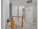 Upstairs hallway features a wooden banister and access to rooms with neutral carpet and paint at 7019 Bellard Ct, Raleigh, NC 27617