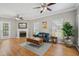 Open-concept living room with hardwood floors, fireplace, and neutral paint scheme with lots of light at 7019 Bellard Ct, Raleigh, NC 27617