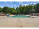 Community pool with lane markers, surrounded by fencing and lush greenery at 7019 Bellard Ct, Raleigh, NC 27617