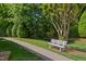 Scenic community path with a bench, surrounded by lush landscaping at 7019 Bellard Ct, Raleigh, NC 27617