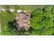 Overhead view of beautiful home featuring a brown roof, deck, patio, and lush greenery at 7212 Donneeford Rd, Wake Forest, NC 27587