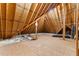 Unfinished attic space with exposed rafters, wood flooring, insulation and ductwork at 7212 Donneeford Rd, Wake Forest, NC 27587