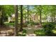 Picturesque backyard featuring a stone path leading through lush trees and greenery at 7212 Donneeford Rd, Wake Forest, NC 27587