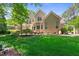 Charming backyard featuring a lush lawn and a home exterior with arched windows at 7212 Donneeford Rd, Wake Forest, NC 27587
